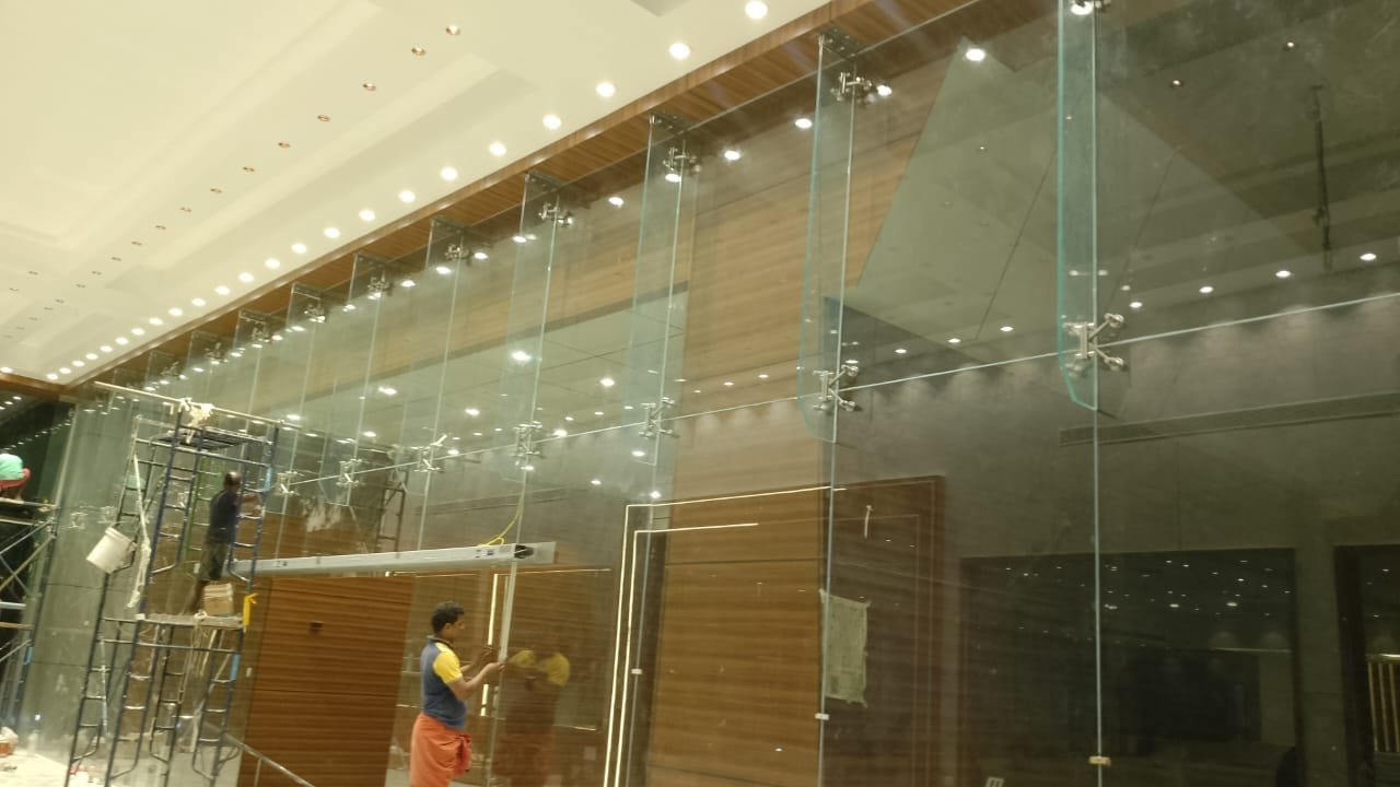 Commercial showroom glass facade and metal framing fabrication in Kerala